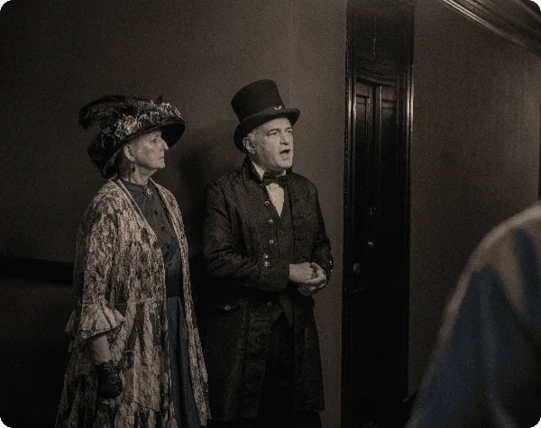 Two paranormal experts standing in front of the 218 haunted room