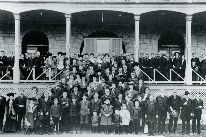 Historical photo of a group of people standing outside of the 1886 Crescent Hotel